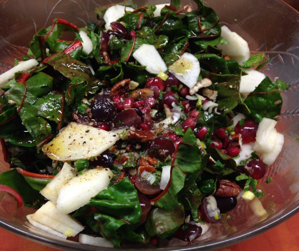 Mangoldsalat mit Birne, Granatapfelkernen, Trauben, Pekan Nüssen und Dattel Vinaigrette