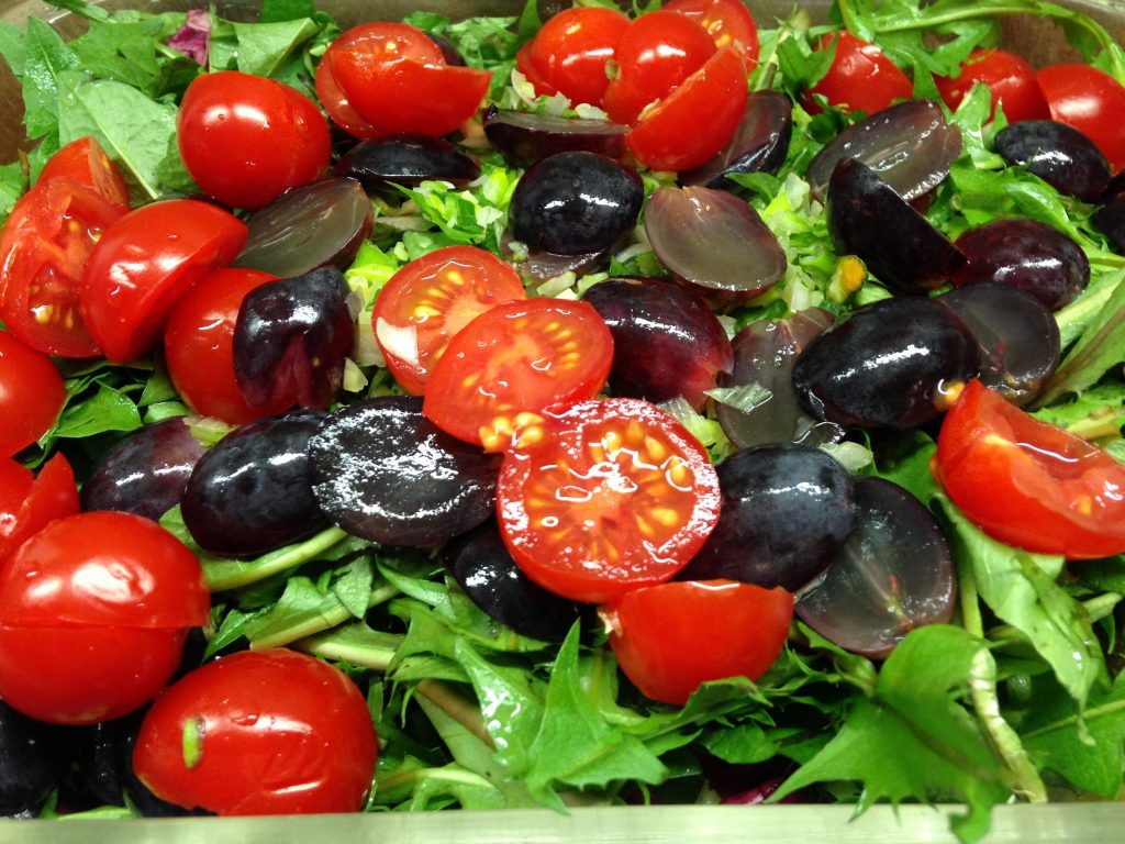Löwenzahn Salat mit Avocado, Radicchio, Trauben, Tomaten und Kürbiskernen